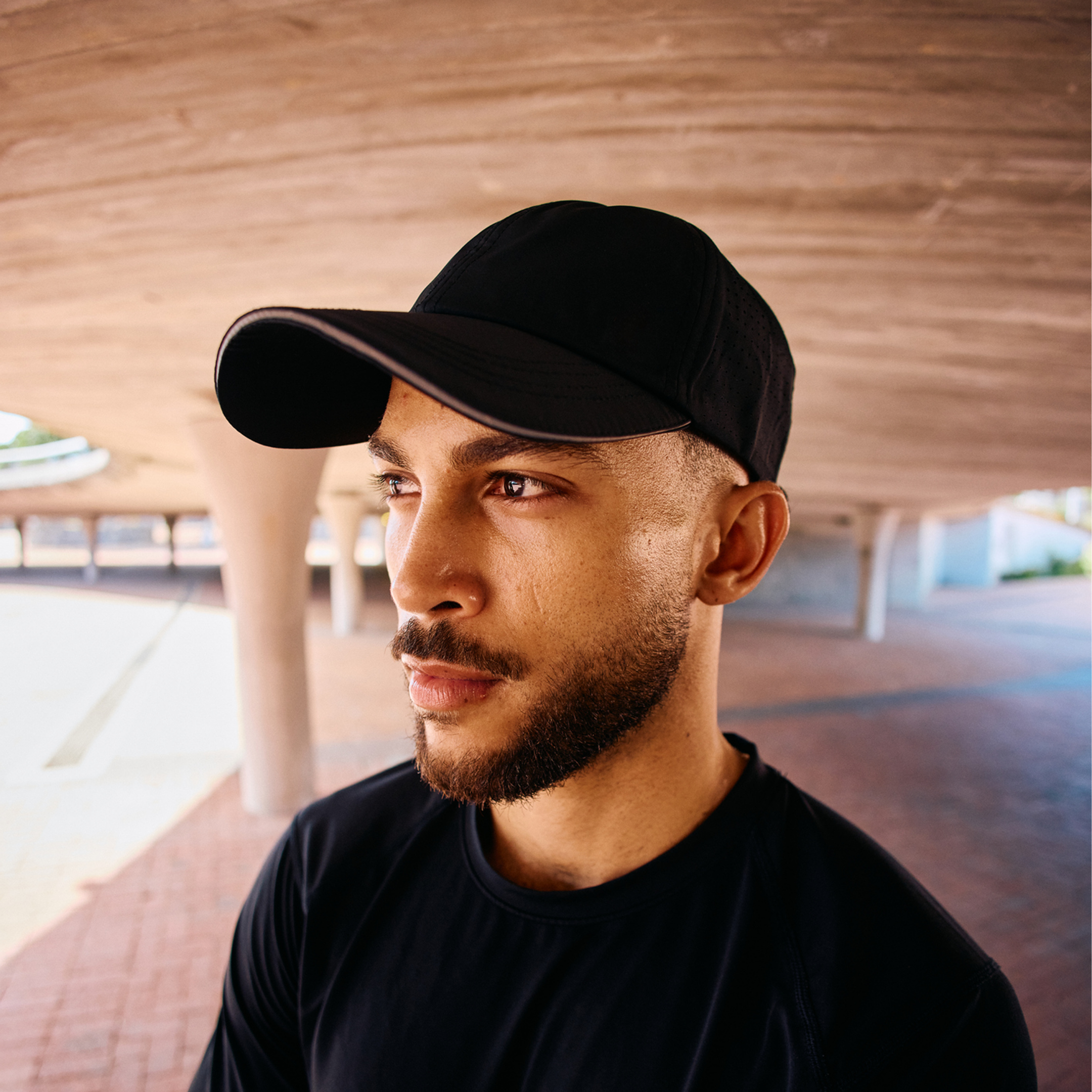 Bearded man wearing a black baseball cap